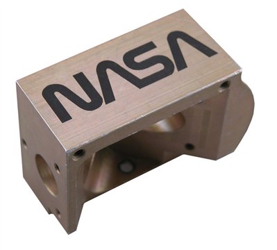 Shows a laser marked aerospace part that features the NASA logo.
