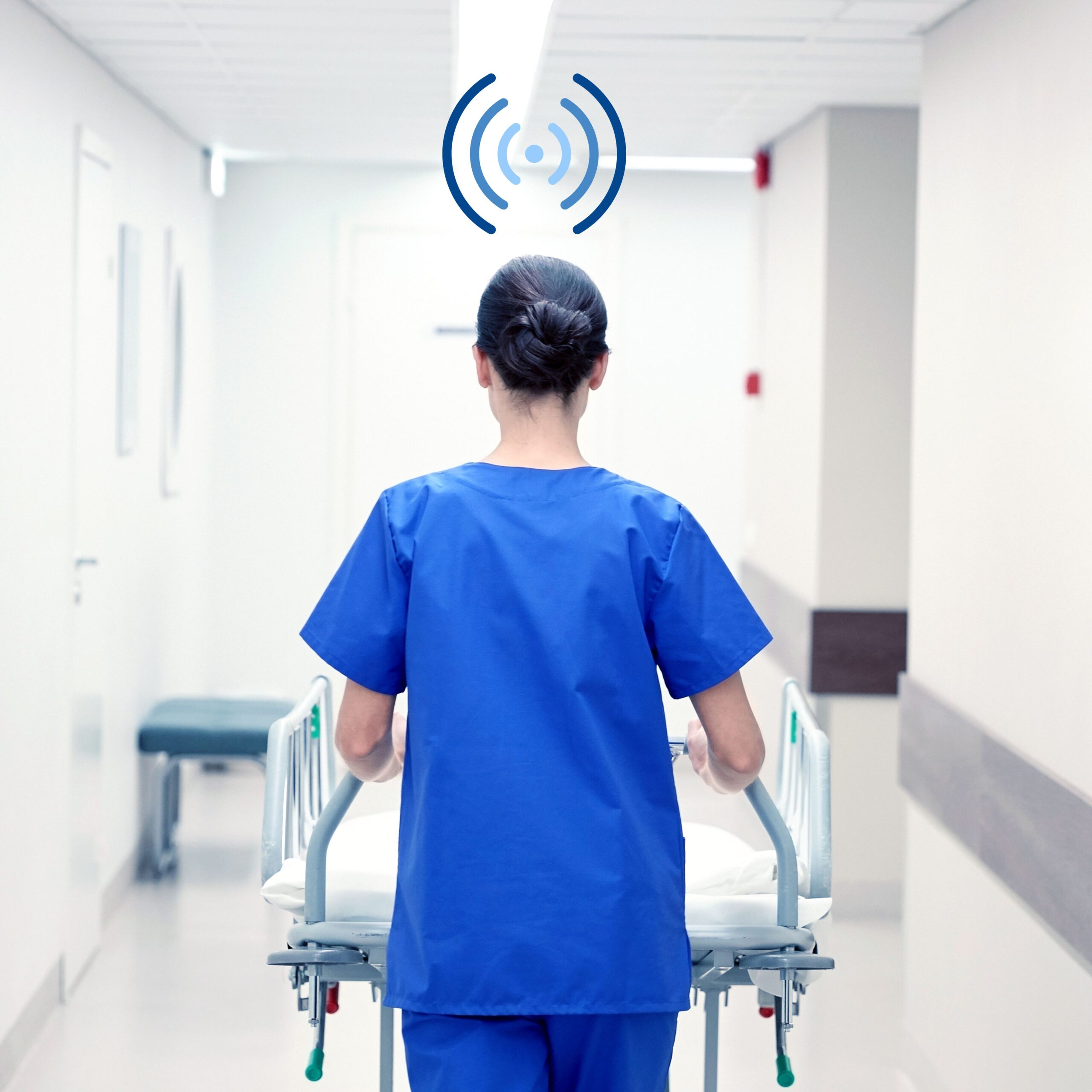 Shows a nurse pushing a gurney down a hospital hallway